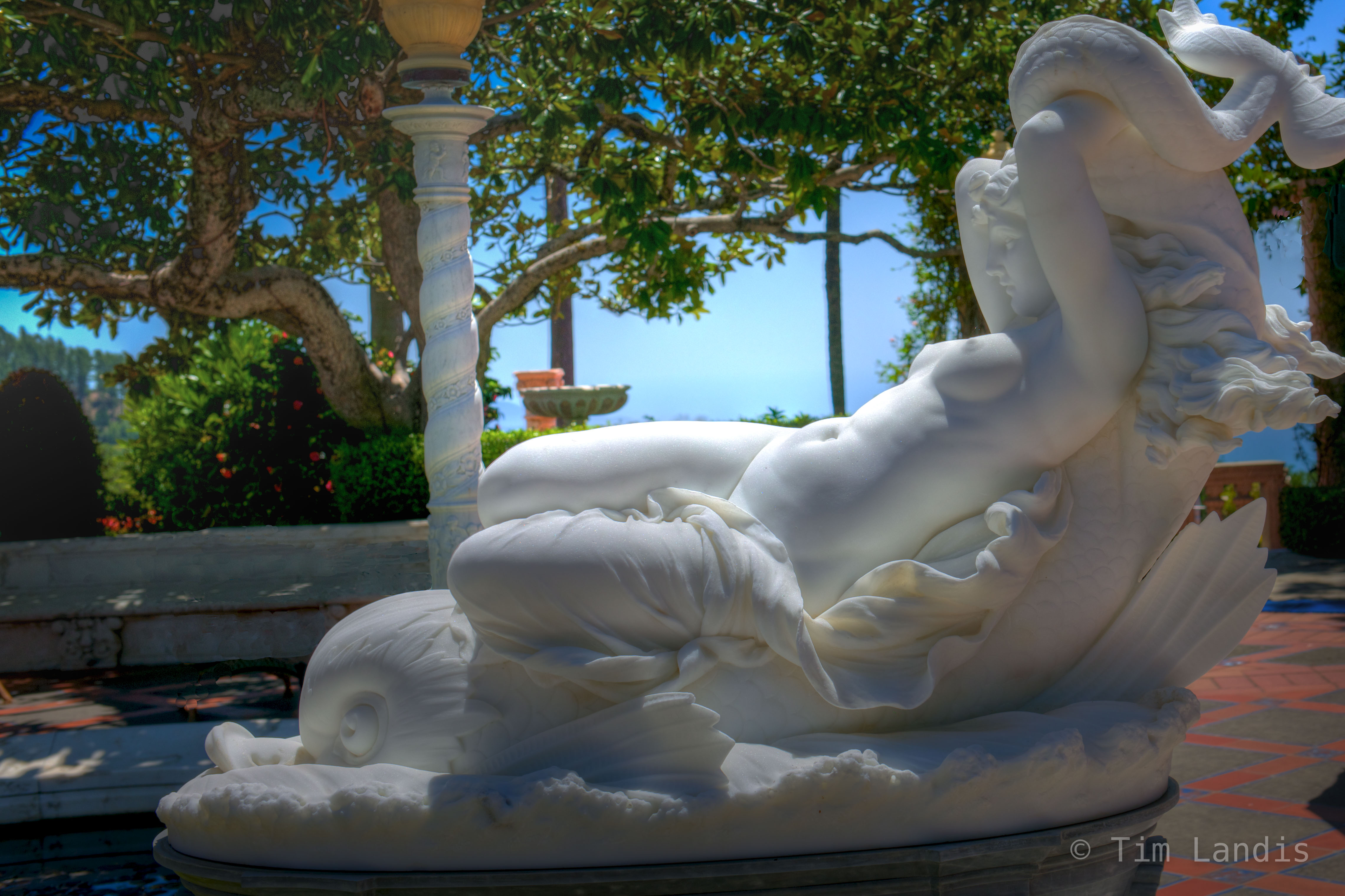 A nearly flawless piece of marble is carved into a sensual statue reclining by the pool